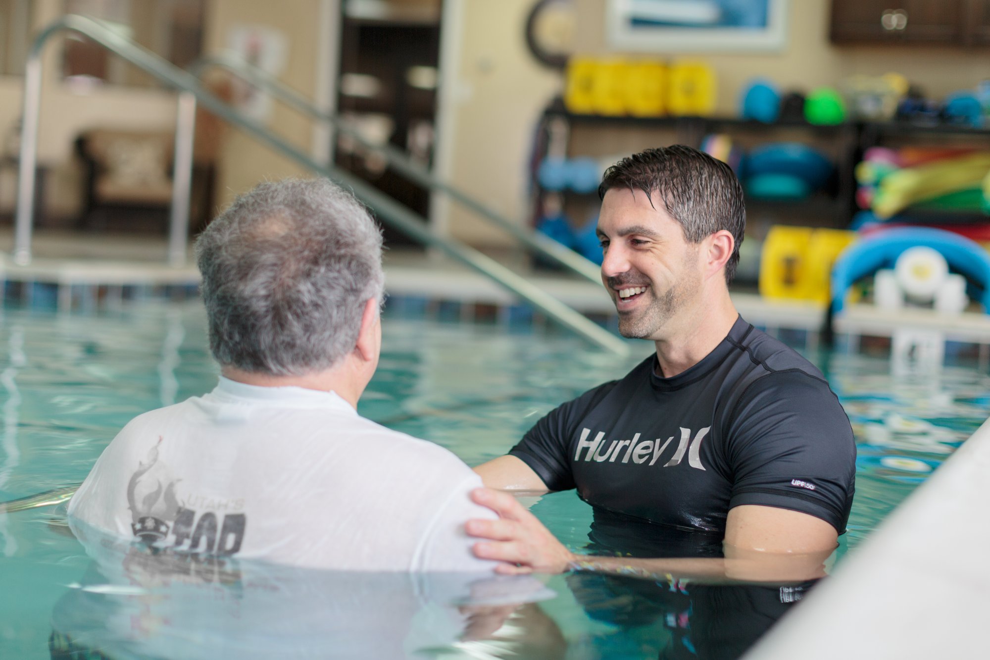Therapist working with patient in aquatic therapy